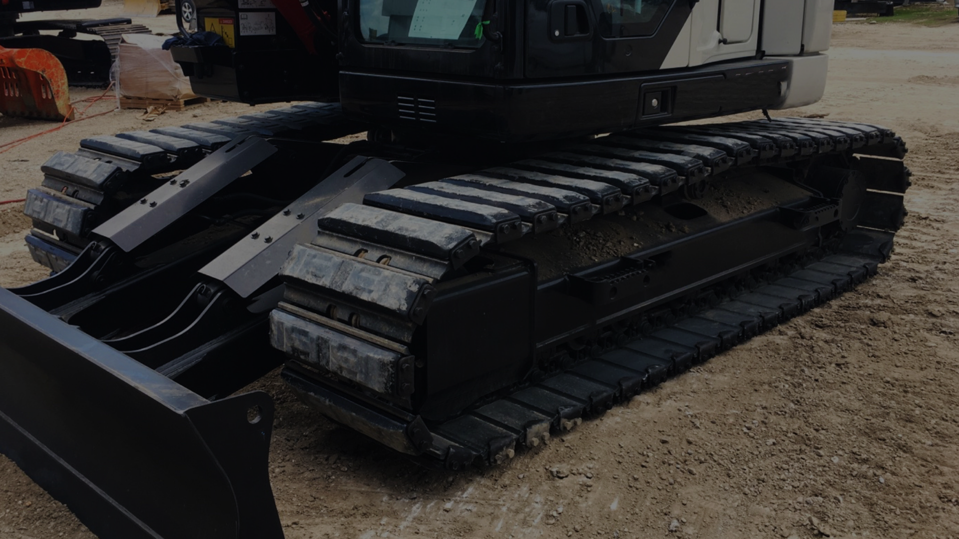 excavator with track pads